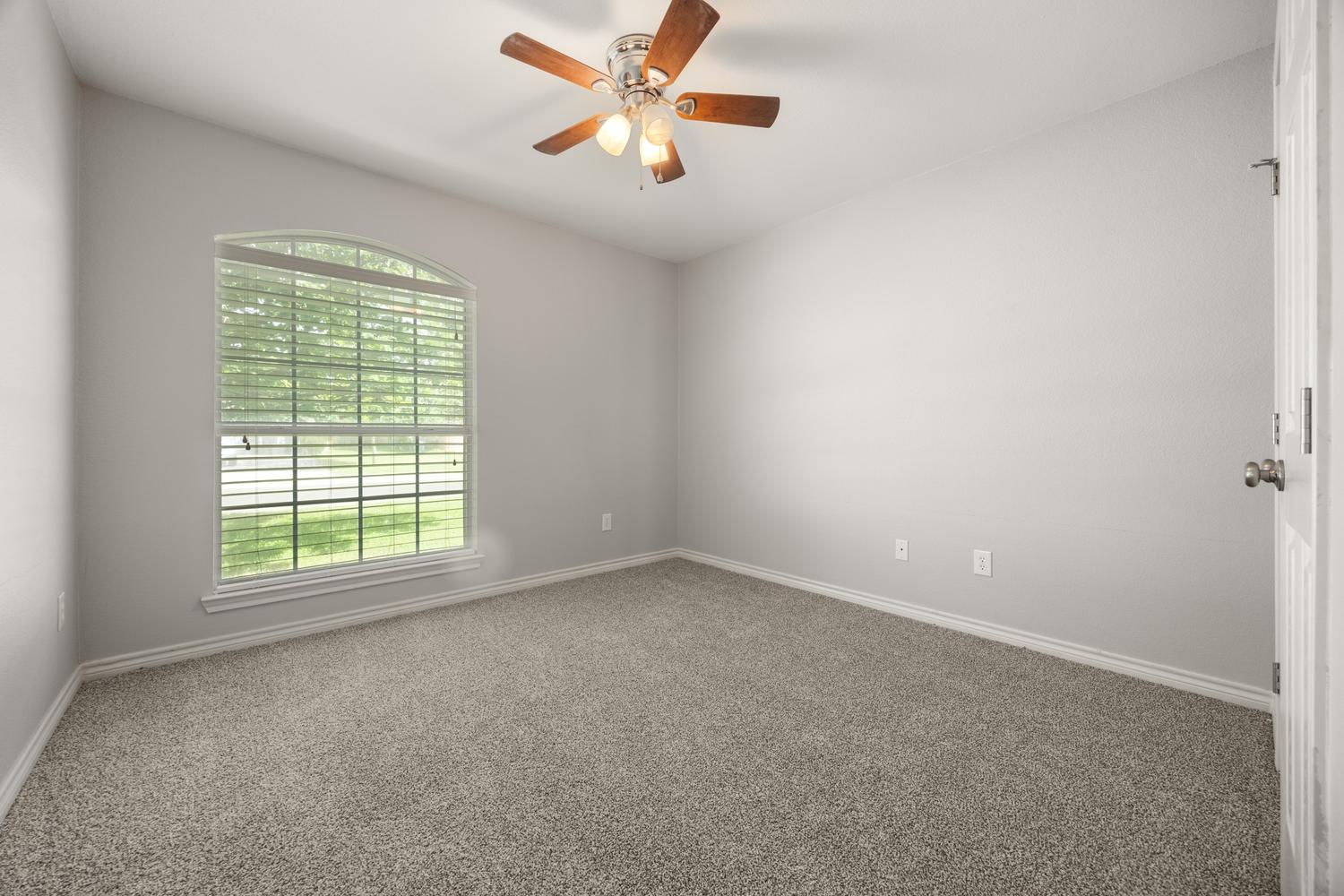 521 Britni Loop Kyle, TX 78640 - Photo 15 of 23 an empty room with a window and a fan