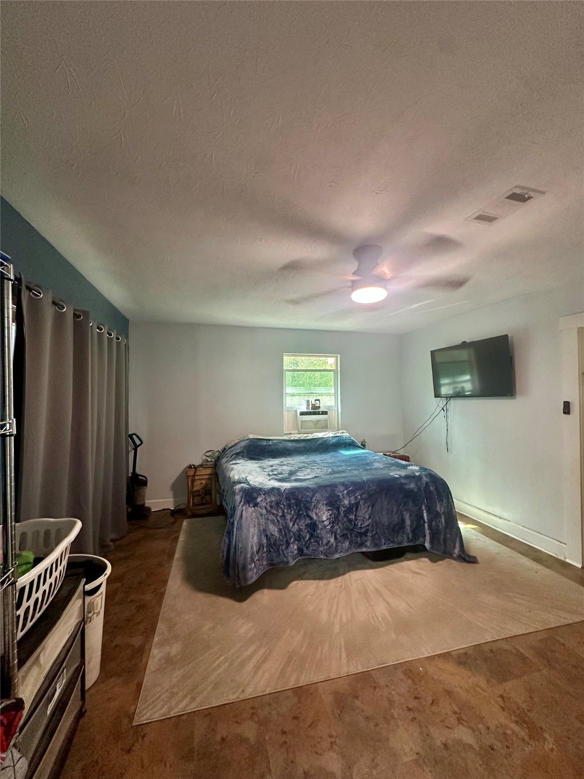 11140 FM 1484 Road Conroe, TX 77303 - Photo 42 of 43 a bedroom with a bed and a flat screen tv