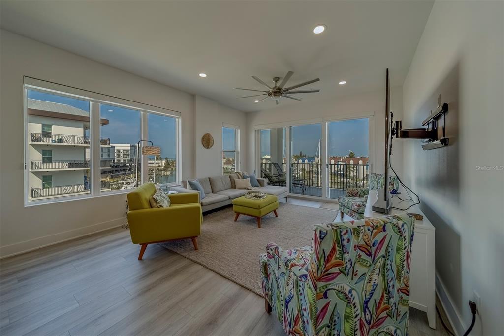 400 150th Avenue, Unit 407 Madeira Beach, FL 33708 - Photo 12 of 59 a living room with furniture and a table