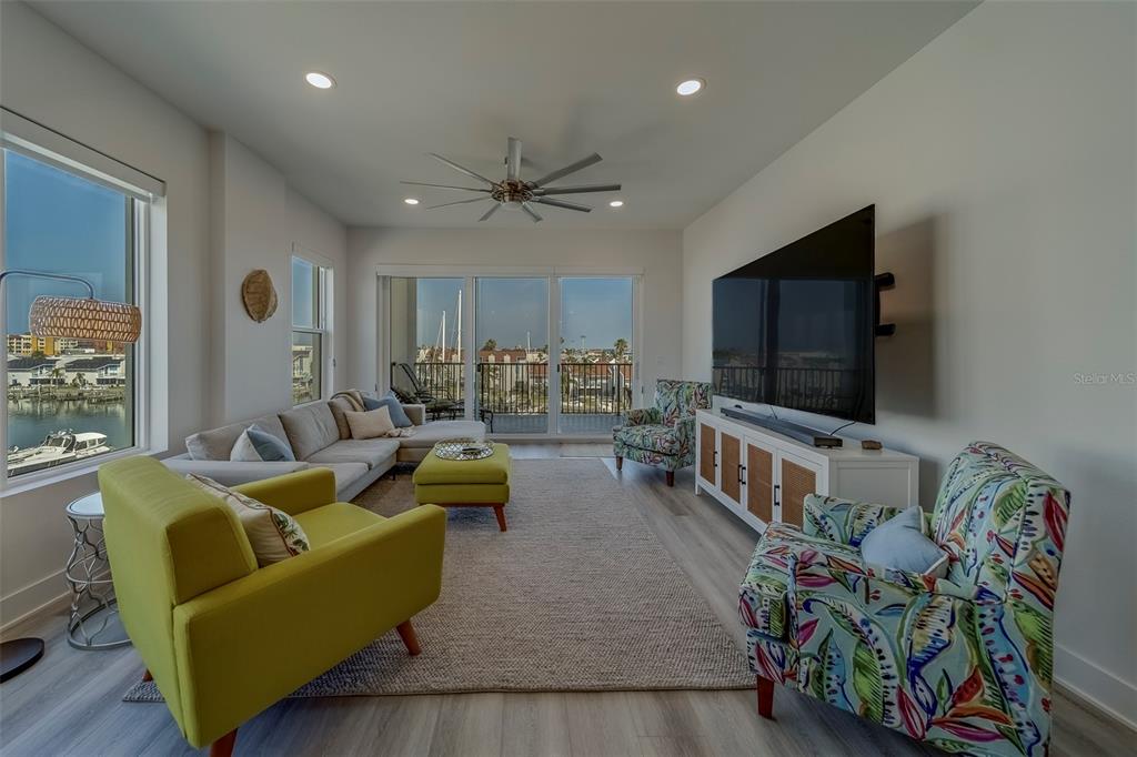 400 150th Avenue, Unit 407 Madeira Beach, FL 33708 - Photo 13 of 59 a living room with furniture and a flat screen tv