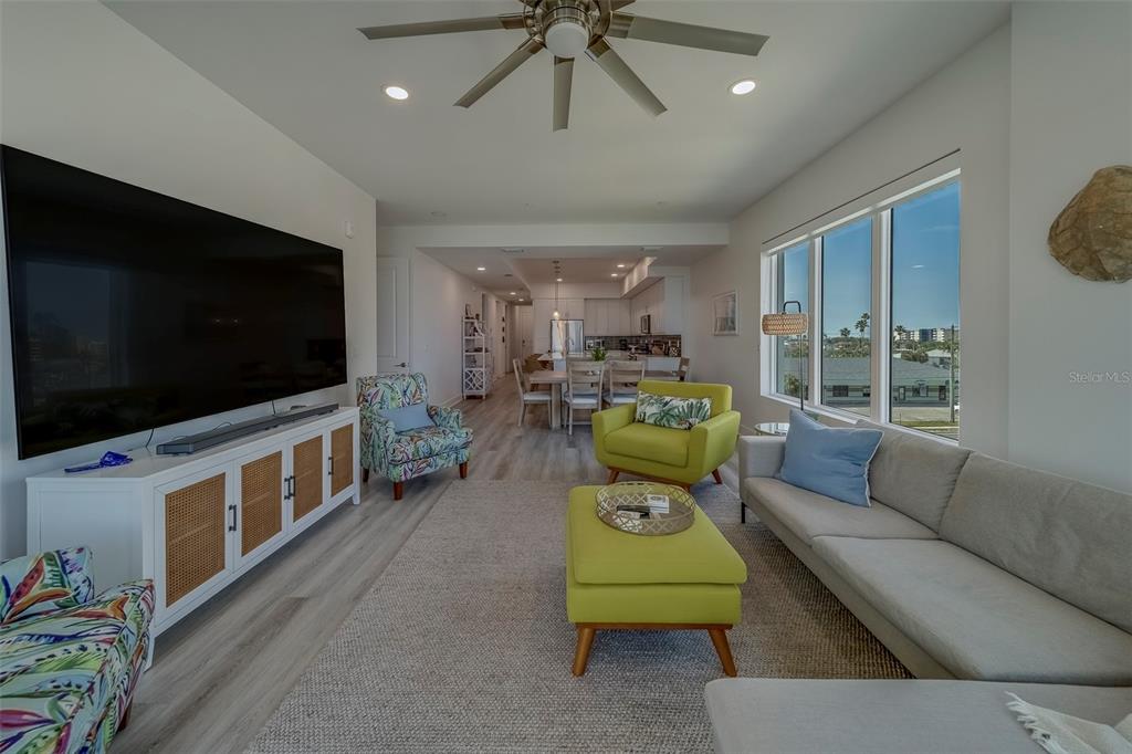 400 150th Avenue, Unit 407 Madeira Beach, FL 33708 - Photo 15 of 59 a living room with furniture and a flat screen tv