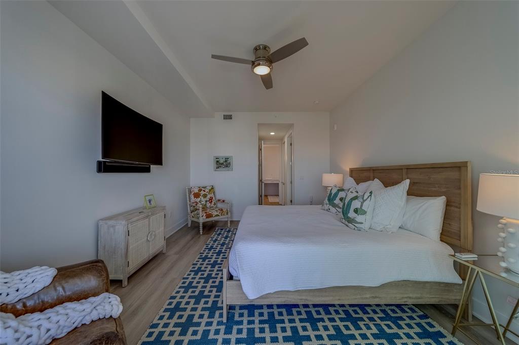 400 150th Avenue, Unit 407 Madeira Beach, FL 33708 - Photo 17 of 59 a living room with furniture and a flat screen tv