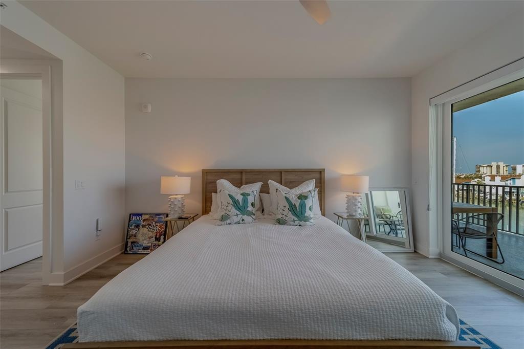 400 150th Avenue, Unit 407 Madeira Beach, FL 33708 - Photo 18 of 59 a bedroom with a bed and a window