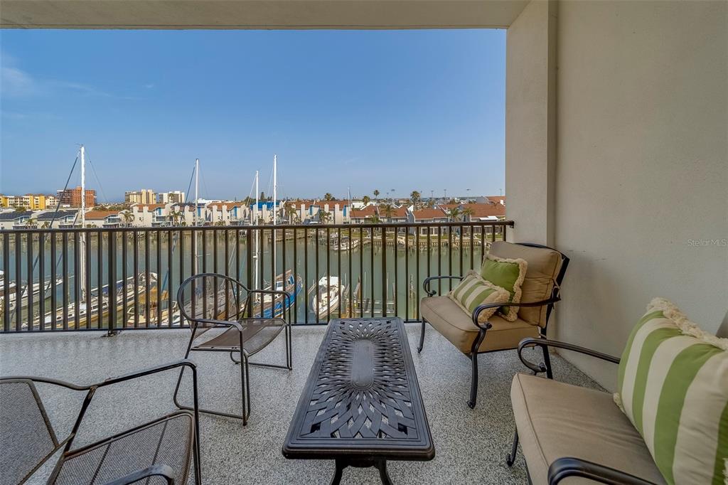 400 150th Avenue, Unit 407 Madeira Beach, FL 33708 - Photo 19 of 59 a view of a chairs and table in patio