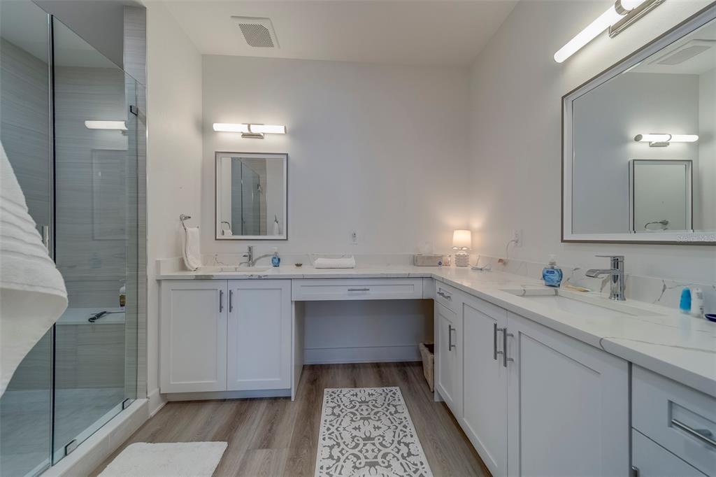 400 150th Avenue, Unit 407 Madeira Beach, FL 33708 - Photo 20 of 59 a bathroom with a sink and a mirror