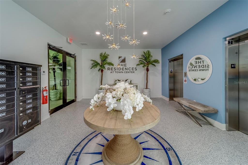 400 150th Avenue, Unit 407 Madeira Beach, FL 33708 - Photo 2 of 59 a view of a dining room with furniture and wooden floor