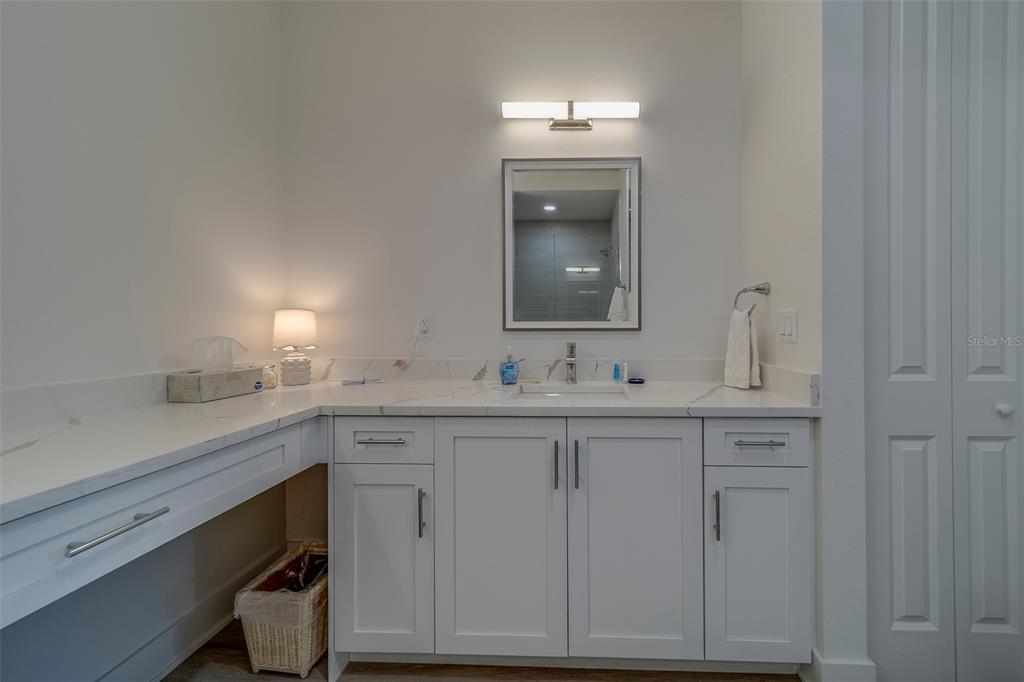 400 150th Avenue, Unit 407 Madeira Beach, FL 33708 - Photo 23 of 59 a bathroom with a sink vanity and mirror