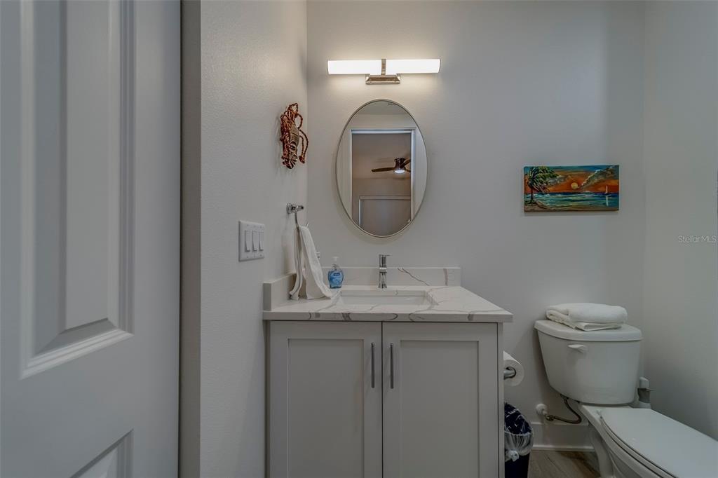 400 150th Avenue, Unit 407 Madeira Beach, FL 33708 - Photo 26 of 59 a bathroom with a toilet a sink and mirror