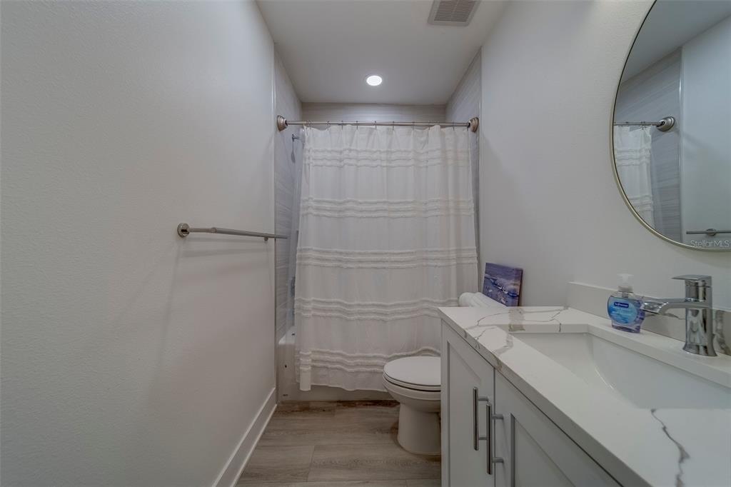 400 150th Avenue, Unit 407 Madeira Beach, FL 33708 - Photo 32 of 59 a bathroom with a sink a toilet and shower