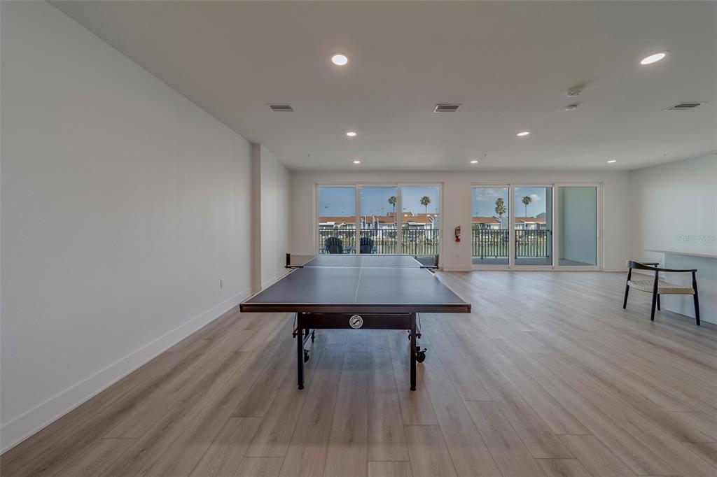 400 150th Avenue, Unit 407 Madeira Beach, FL 33708 - Photo 46 of 59 a view of a room with furniture and wooden floor