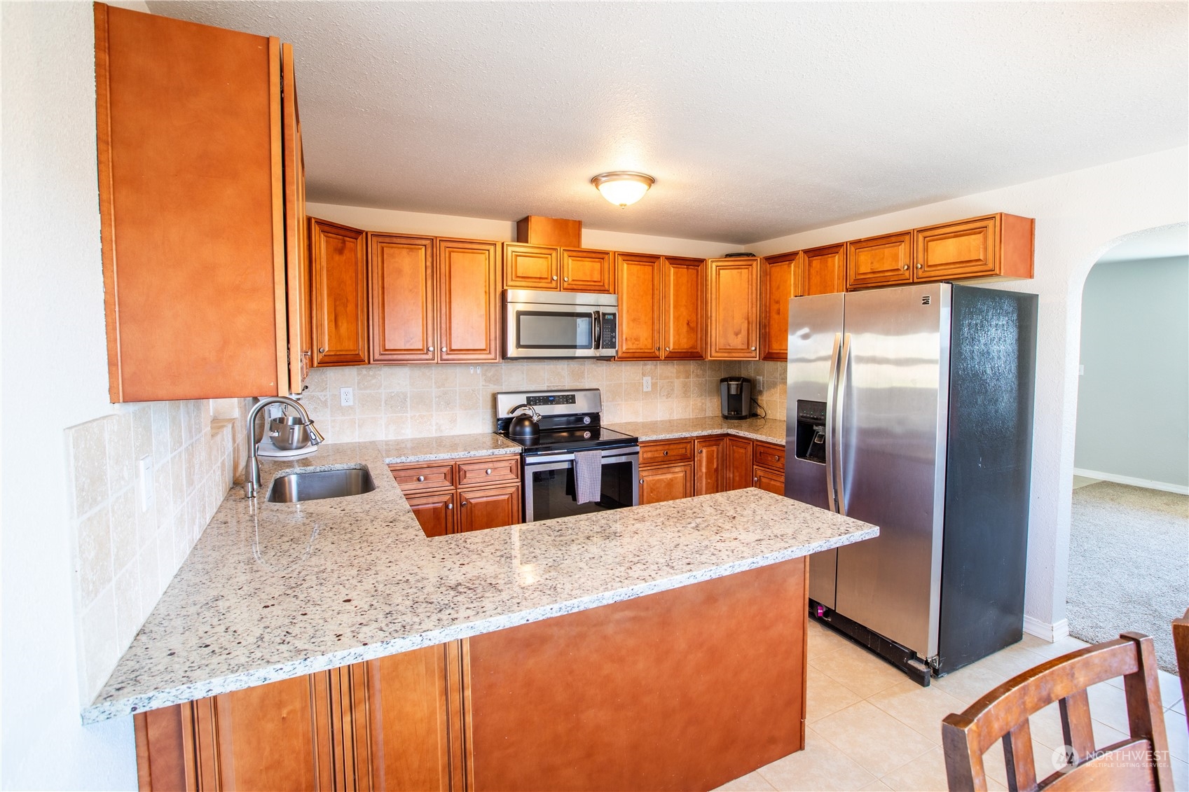 275 Patrick Road Ephrata, WA 98823 - Photo 19 of 35 a kitchen with stainless steel appliances granite countertop a sink refrigerator and microwave