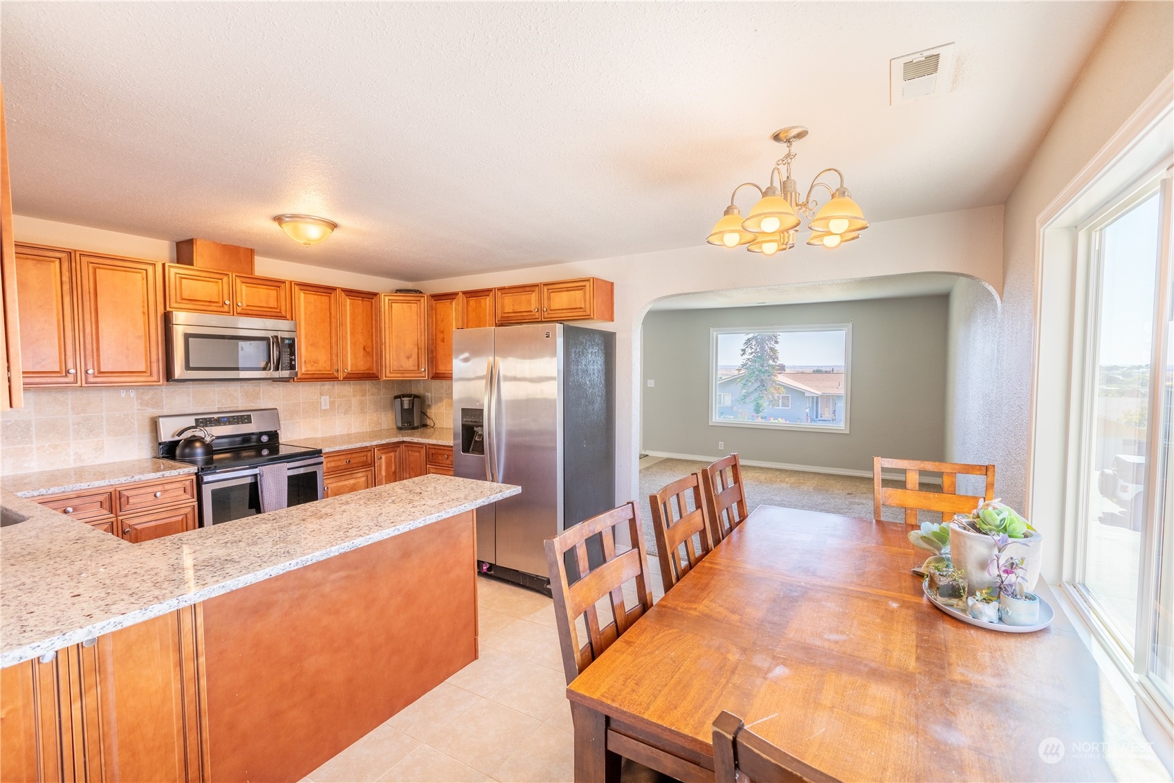 275 Patrick Road Ephrata, WA 98823 - Photo 25 of 35 a kitchen with stainless steel appliances granite countertop a sink refrigerator and microwave