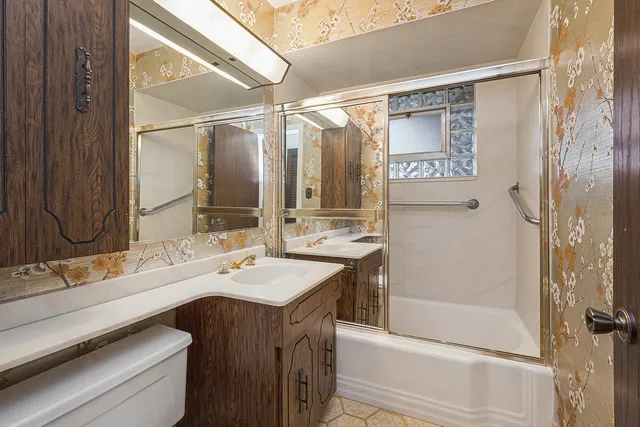 a bathroom with a double vanity sink mirror and shower