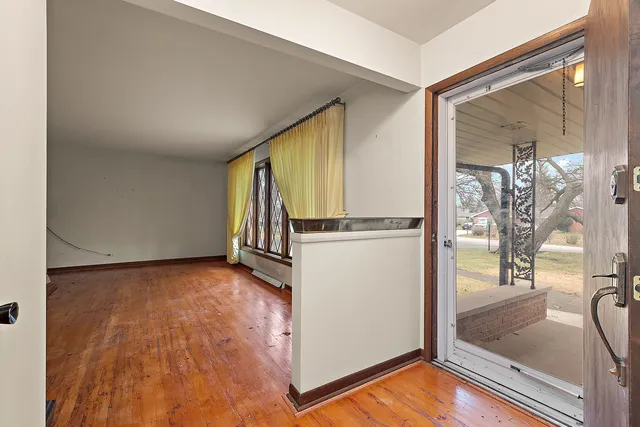 a view of a room with wooden floor
