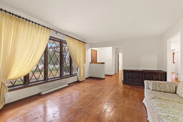 a living room with furniture and large windows