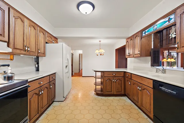 a kitchen with stainless steel appliances granite countertop a sink counter space cabinets and a large window