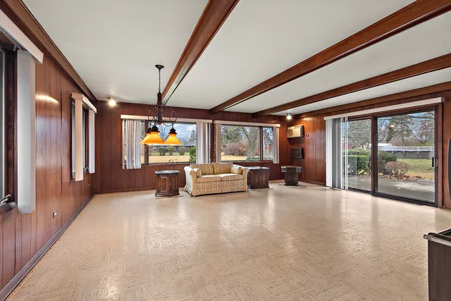 a view of a livingroom with furniture and a floor to ceiling window