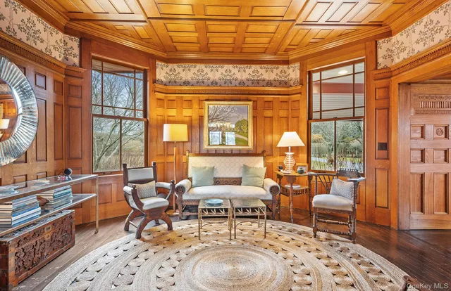a view of a dining room with furniture a chandelier and wooden floor