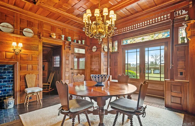 a dining room with furniture a fireplace and wooden floor