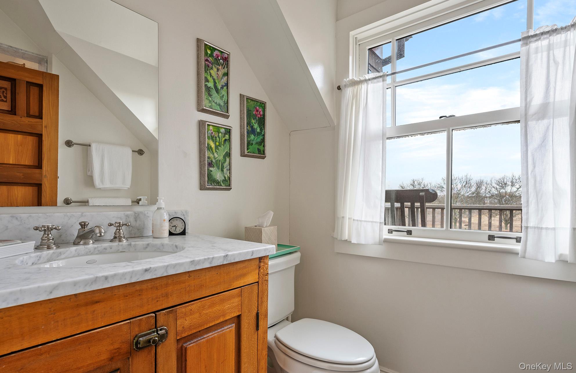 322 Rose Hill Road Water Mill, NY 11976 - Photo 5 of 33 a bathroom with a granite countertop sink mirror and a window