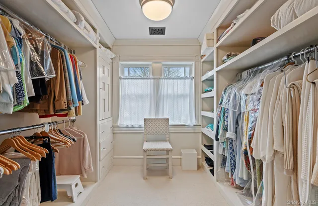 a spacious bathroom with a tub sink and mirror