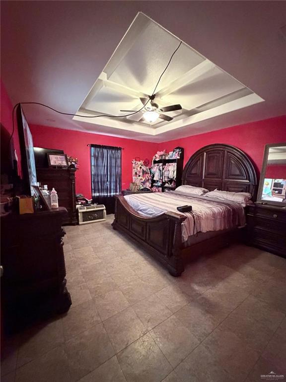 7123 Elisa Street Mission, TX 78574 - Photo 5 of 10 a bedroom with a bed and a ceiling fan