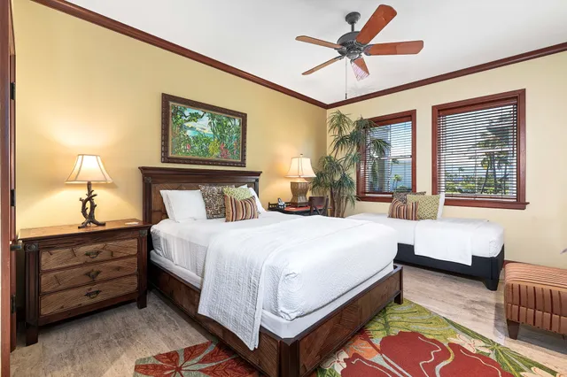 a bedroom with a bed a dresser next to a window