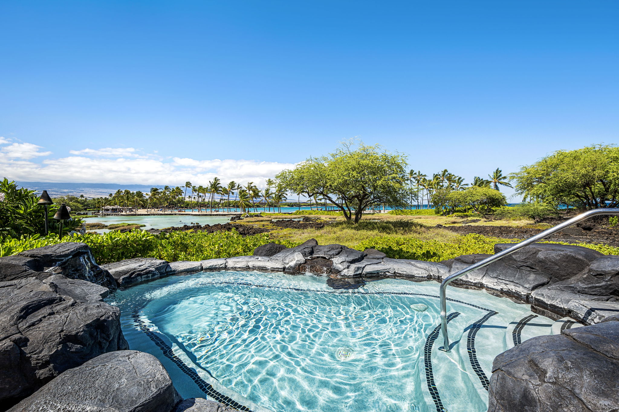 69-1000 Kolea Kai Circle, Unit 15L Waikoloa, HI 96738 - Photo 28 of 29 a view of a swimming pool and lounge chairs in back yard of the house