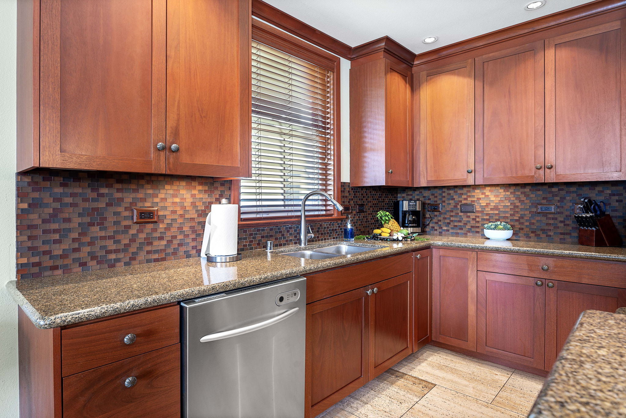 69-1000 Kolea Kai Circle, Unit 15L Waikoloa, HI 96738 - Photo 6 of 29 a kitchen with stainless steel appliances granite countertop wooden cabinets a sink and dishwasher