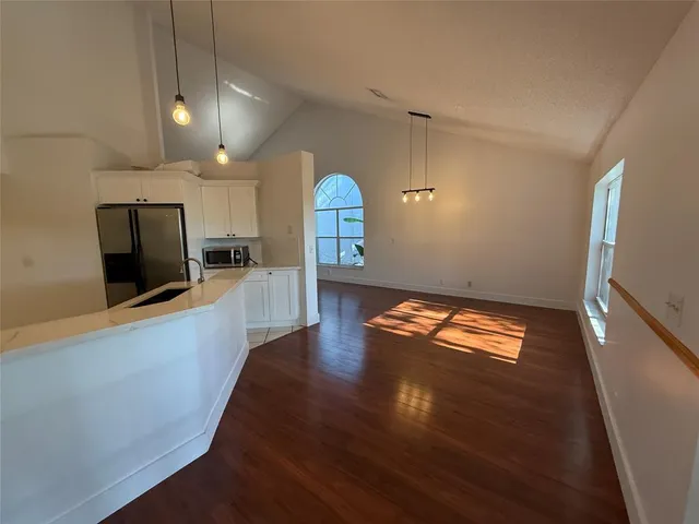 a view of a kitchen with a sink and a stove top oven