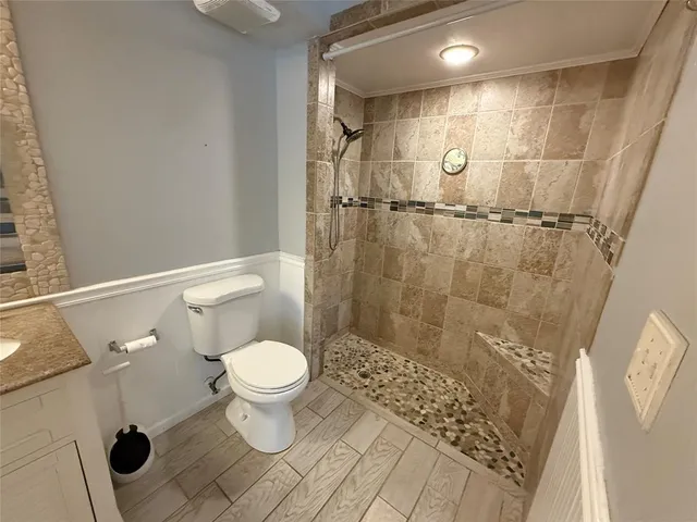 a bathroom with a toilet and a shower
