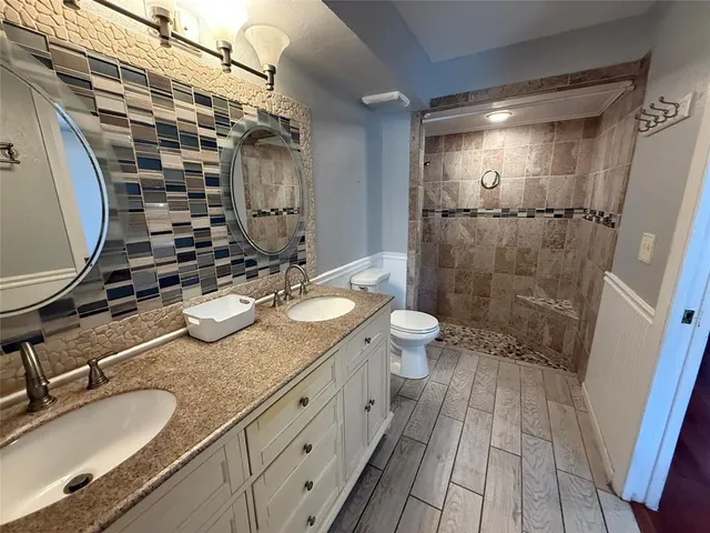 a bathroom with a sink double vanity and a mirror