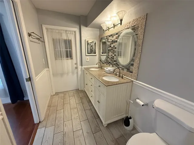 a bathroom with sink toilet and shower