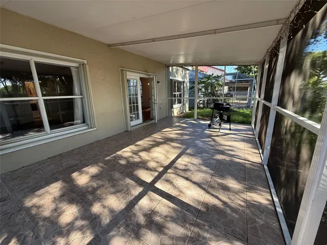 a view of a porch with chairs and backyard