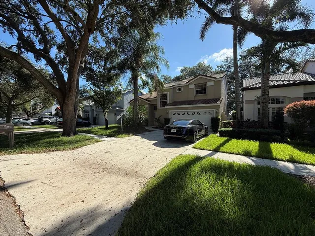 a yellow house with trees in front of it