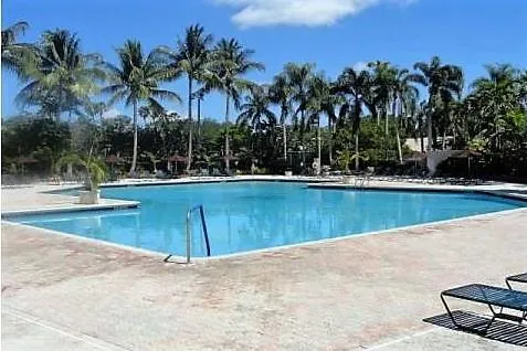 a view of a swimming pool with a yard