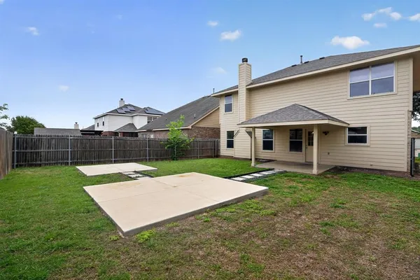 a view of a backyard with wooden fence