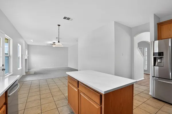 a kitchen with kitchen island a counter top space appliances and cabinets