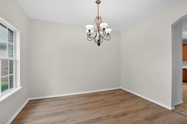 a view of a room with wooden floor and windows