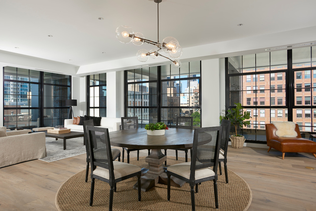 351 West Huron Street, Unit 4 Chicago, IL 60654 - Photo 13 of 30 a view of a dining room with furniture large windows and wooden floor