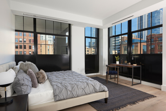 351 West Huron Street, Unit 4 Chicago, IL 60654 - Photo 23 of 30 a bedroom with a bed and wooden floor