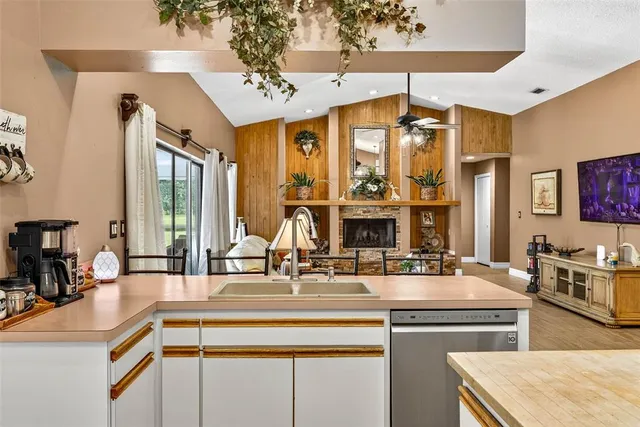 a living room with furniture a flat screen tv and a large window