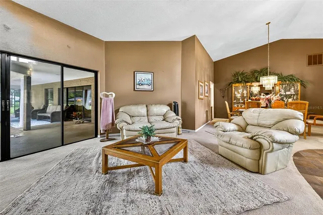 a bathroom with a granite countertop sink a toilet a mirror and window