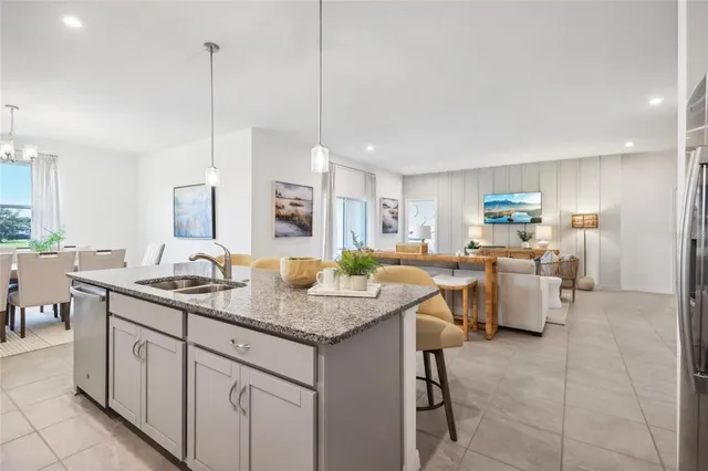 a kitchen with sink cabinets and living room view