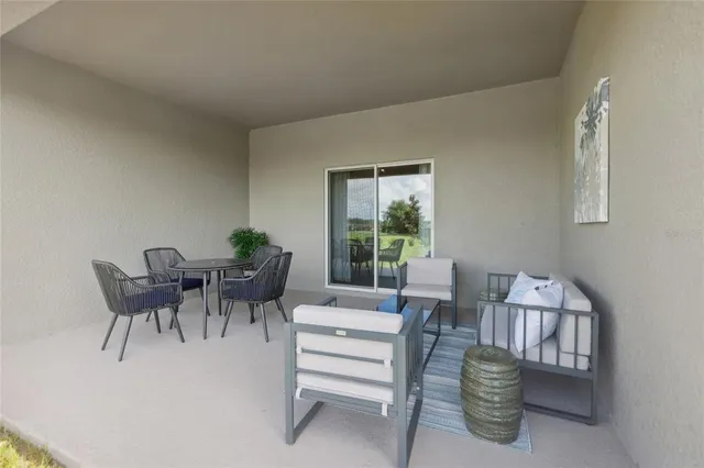 a dining room with furniture and a potted plant