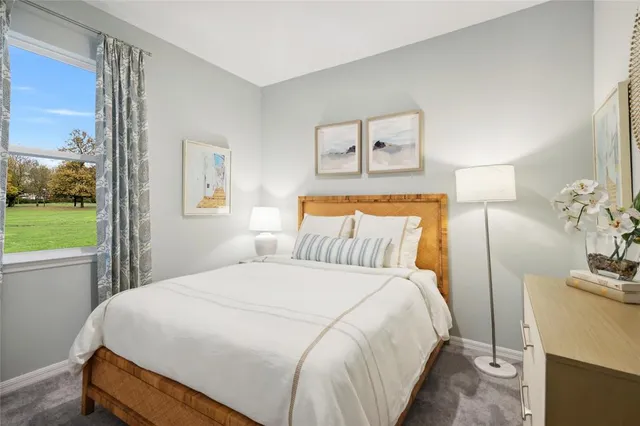 a bedroom with a bed and a potted plant