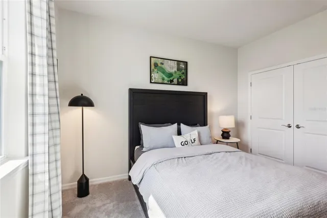 a bedroom with a bed and a night stand