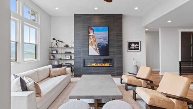 355 East Overlook Loop Hideout, UT 84036 - Photo 9 of 40 Living area featuring a floor-to-ceiling tiled fireplace, linear electric fireplace insert, and high transom windows
