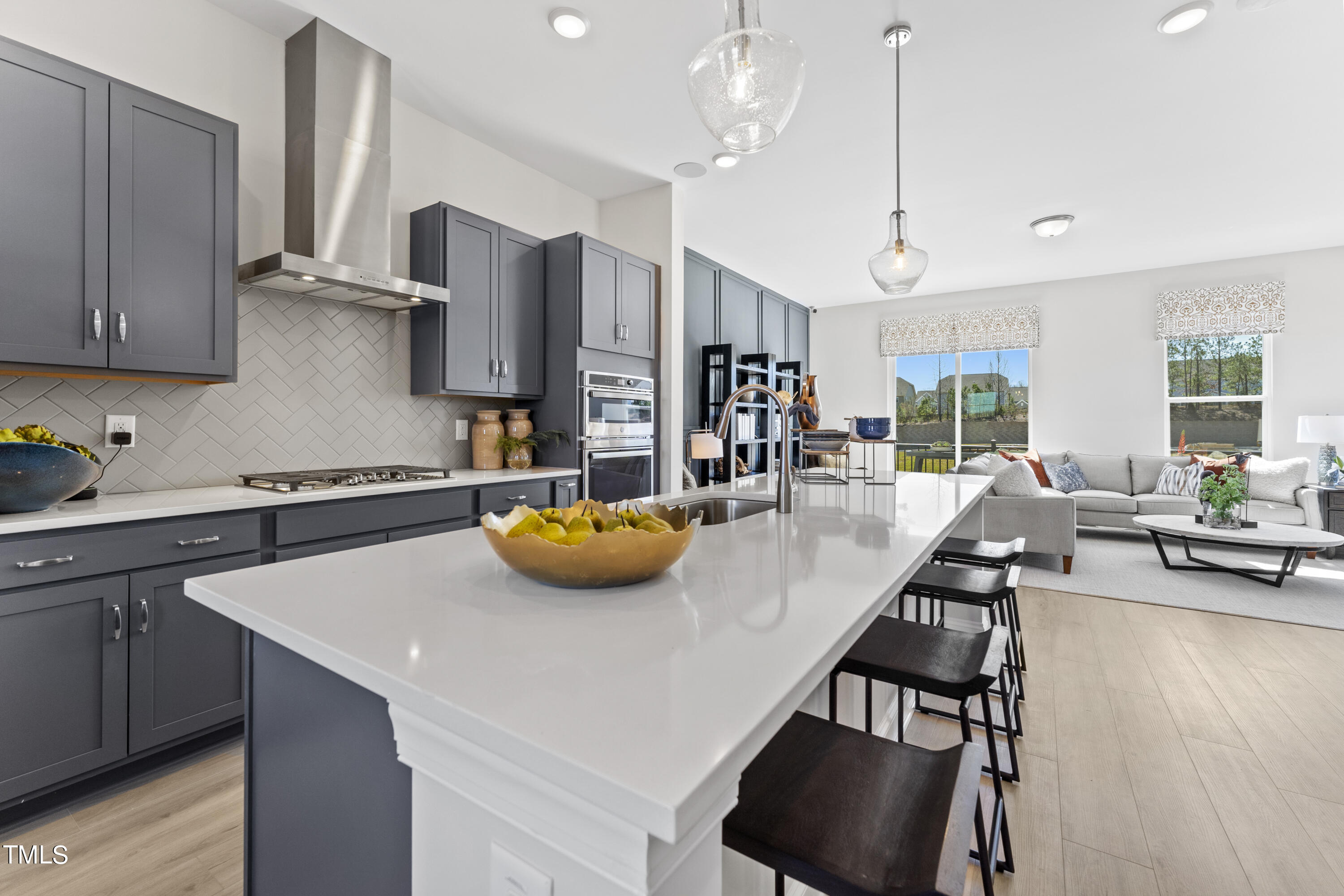 513 Hedrick Ridge Road Cary, NC 27519 - Photo 3 of 30 a kitchen with stainless steel appliances a table chairs and a refrigerator