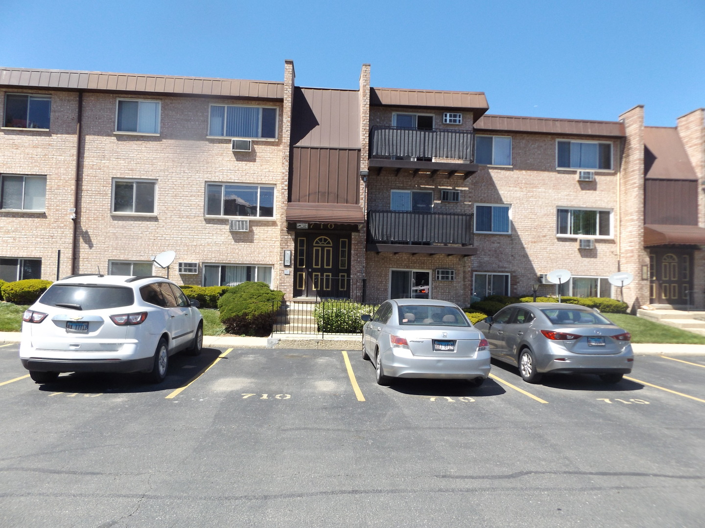 710 West Huntington Commons Road, Unit 3A Mount Prospect, IL 60056 - Photo 2 of 10 a car parked in front of a building